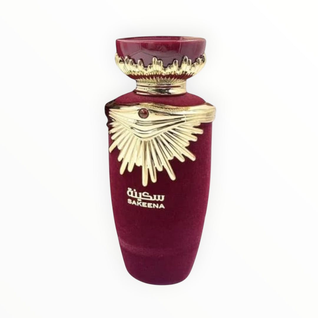 Rimaal Lattafa Sakeena Parfumflakon in Dunkelrot mit goldenen Verzierungen und Samtoptik, 100 ml.